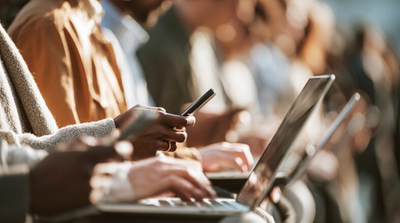 The Role Of Inclusive Content In Building Loyal Audiences Close-up of hands typing on a laptop, screen slightly blurred, modern workspace in the background