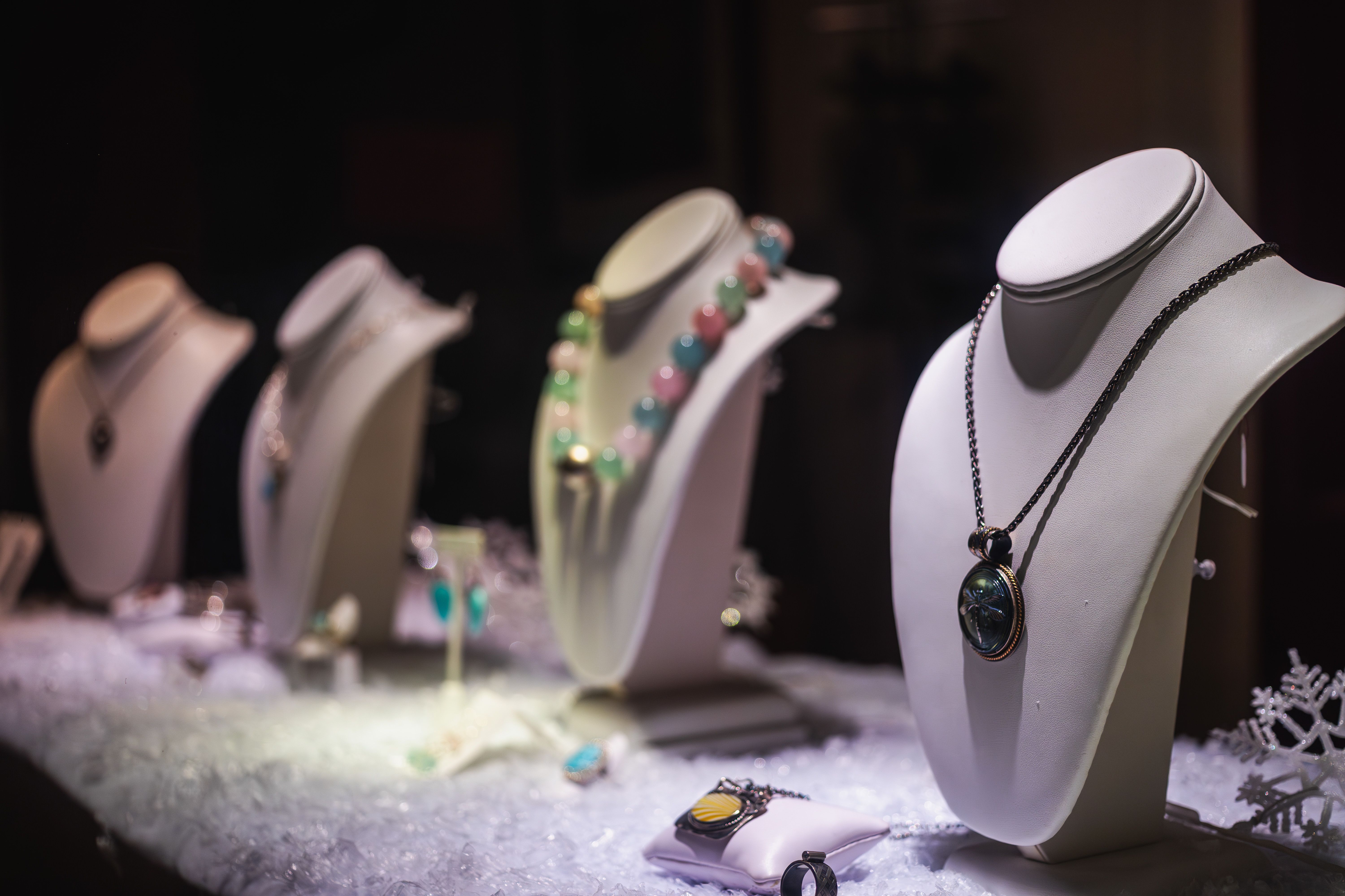Luxury necklaces displayed in a jewelry store, suggesting rarity and high-end desirability.